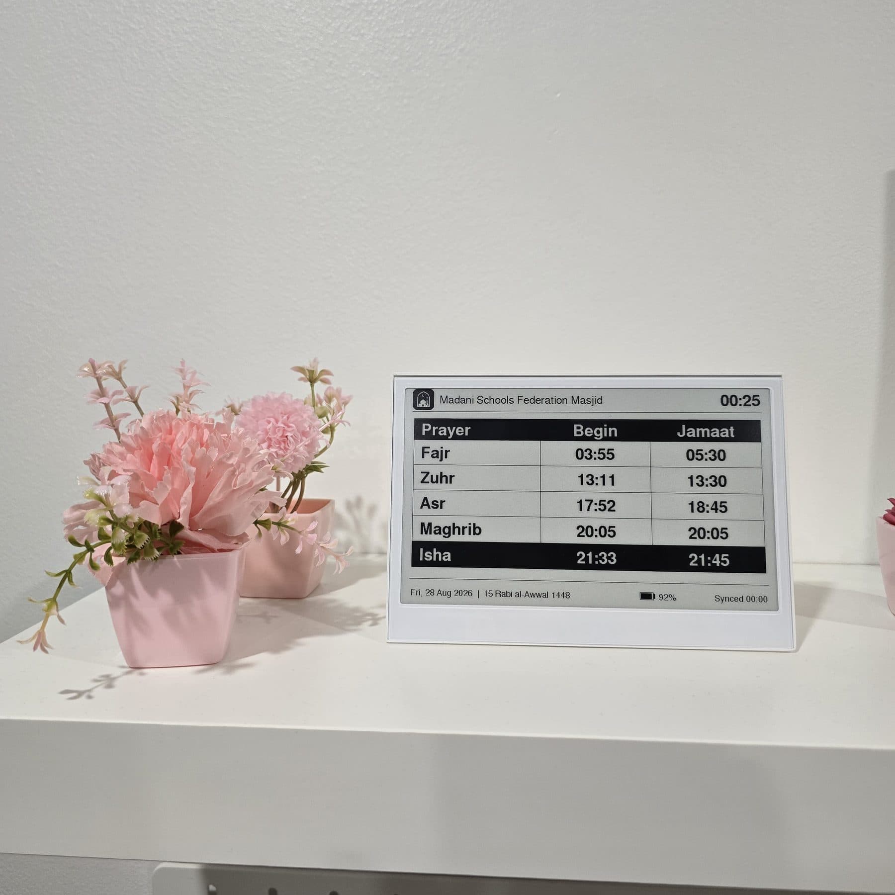 Prayertimes Clock on a shelf, showing the large timetable layout with begin and jamaat times for each prayer